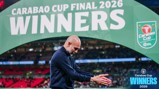 A person clapping in front of a large sign reading 'Carabao Cup Final 2026 Winners'.