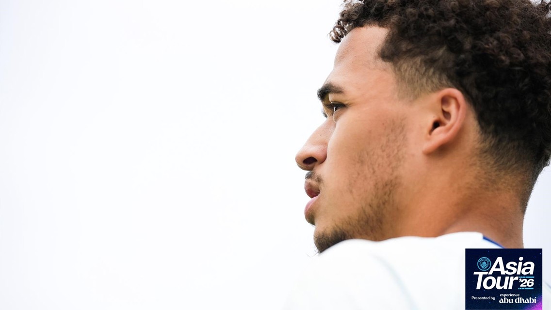 Profile view of a man looking into distance with Asia Tour '26 logo in the corner.