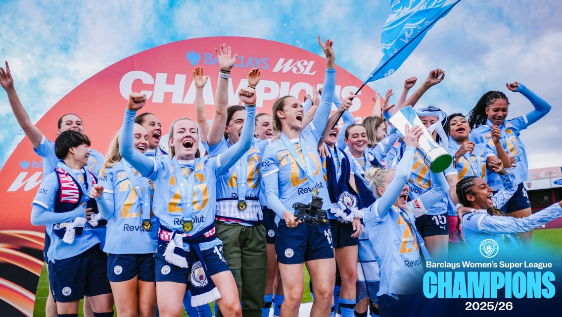 Manchester City Women's team celebrating their Barclays Women's Super League 2025/26 championship win with a trophy and medals.