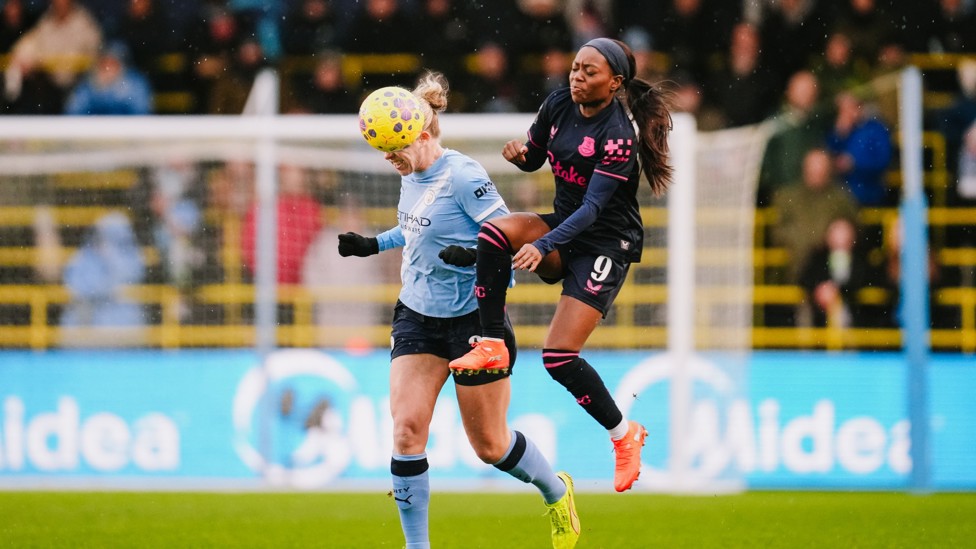 HEAT OF BATTLE : Rebecca Knaak beats Toni Payne to an aerial ball