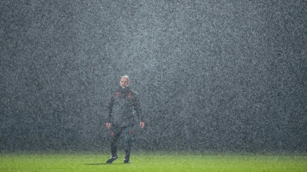 POURING ON PEP : The boss oversees training as the rain comes down at the CFA