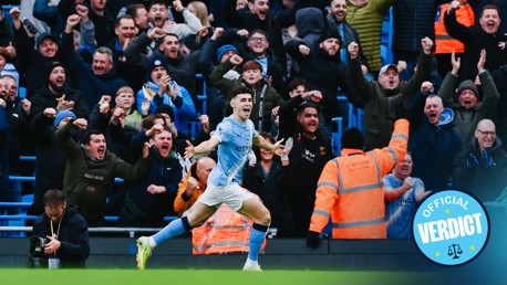 Manchester City player Phil Foden celebrates in front of jubilant fans at the Etihad Stadium with their faces blurred. The image includes a 'VERDICT' symbol.
