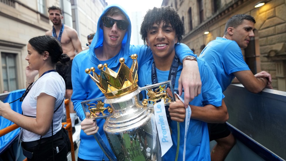MANCHESTER IS BLUE : Lewis and Palmer are full of smiles during the parade through the city centre streets.