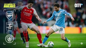 Two soccer players from Arsenal and Manchester City compete for the ball during a Carabao Cup match.