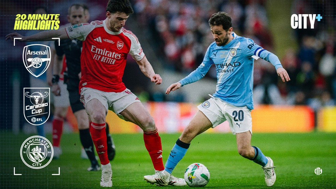 Two soccer players from Arsenal and Manchester City compete for the ball during a Carabao Cup match.