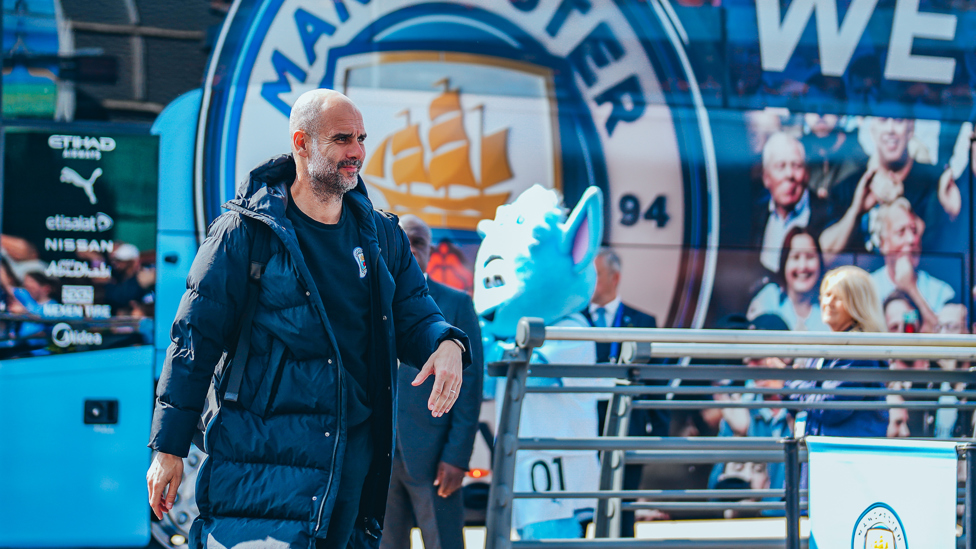 THE BOSS : Pep leads his side into the Etihad ahead of the clash with Newcastle.