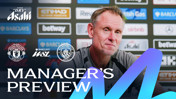 A manager giving a preview for the Manchester United vs. Manchester City match in the Barclays Women's Super League. Background shows sponsor logos and team crests.