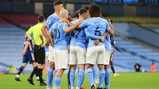GROUP HUG: The players celebrate Sterling's opener.