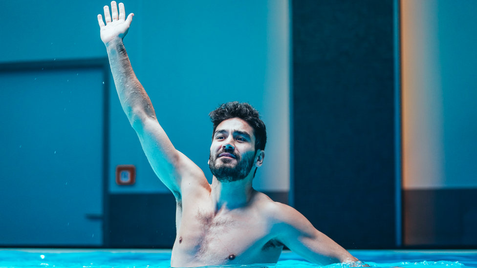 HANDS UP : Ilkay Gundogan rises high in the pool