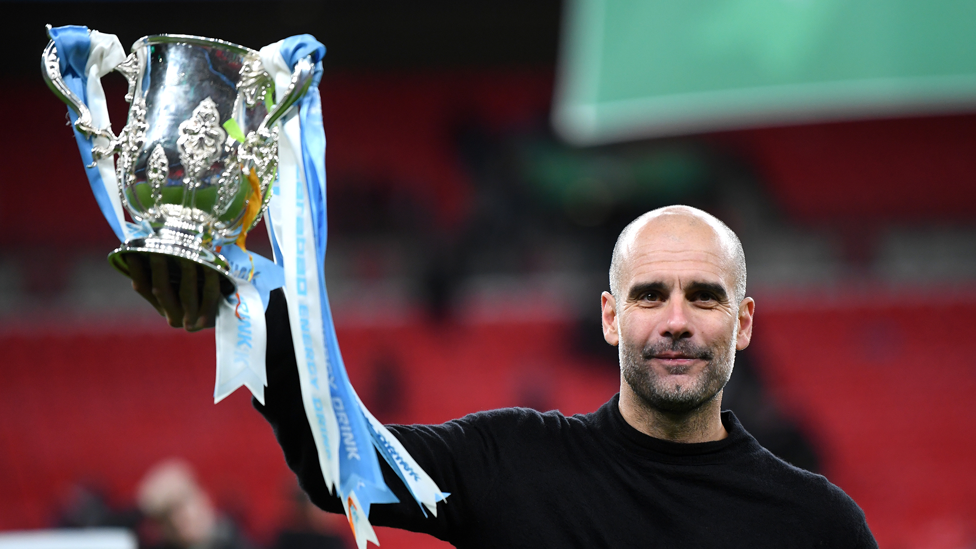 RAISE IT HIGH : He raises aloft yet another Carabao Cup