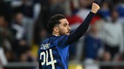 A soccer player wearing a blue jersey with the name 'Cherki' and number '24' celebrates with a fist raised.