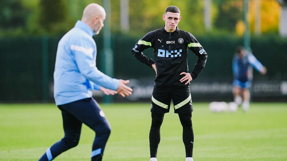 LISTENING INTENTLY : Phil Foden is all ears as he gets tactics off Enzo at the CFA training ground.