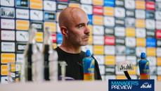 A person sitting at a press conference with background sponsor logos and two bottles on the table. The text 'Manager's Preview' is visible in the bottom right corner.