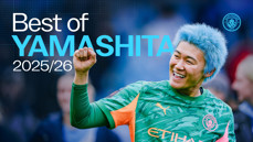 A football player from Manchester City celebrates with a raised fist and a smile, wearing a blue hairstyle and the team's green and orange kit. Text reads 'Best of Yamashita 2025/26' alongside the Manchester City logo.