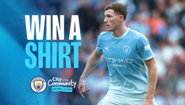 A promotional graphic showing a football player in a Manchester City kit with the text 'Win a Shirt' and Manchester City and City in the Community logos.