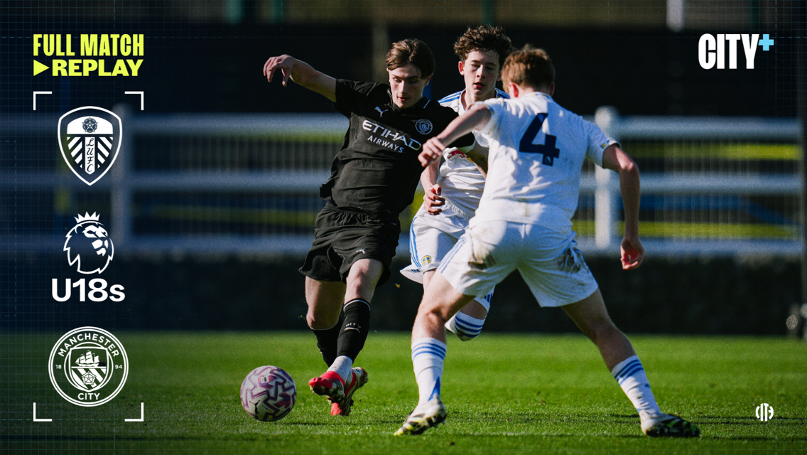 Players from Leeds United and Manchester City U18 teams competing for the ball during a match. The match is available as a full replay on City+.