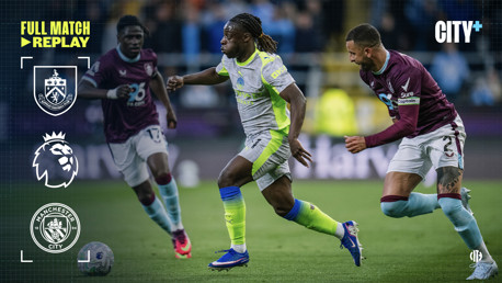 Soccer players from Manchester City and Burnley competing in a match featuring Premier League branding and logos.