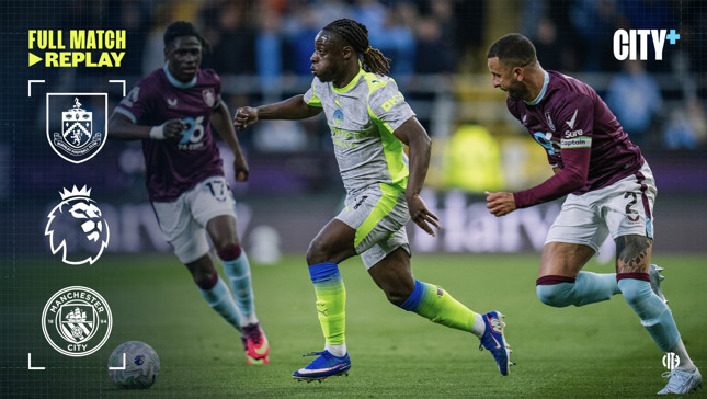 Soccer players from Manchester City and Burnley competing in a match featuring Premier League branding and logos.