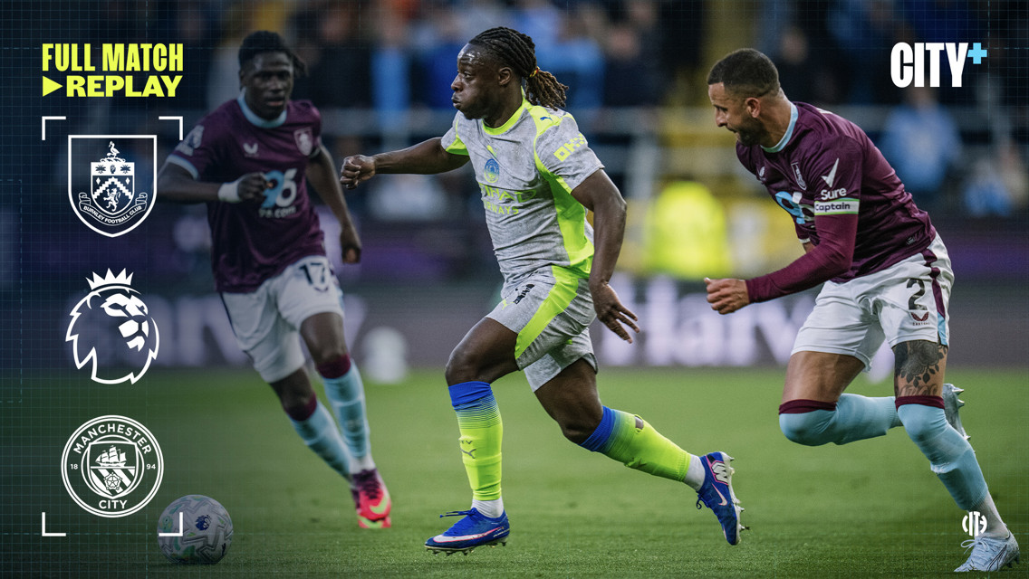 Soccer players from Manchester City and Burnley competing in a match featuring Premier League branding and logos.