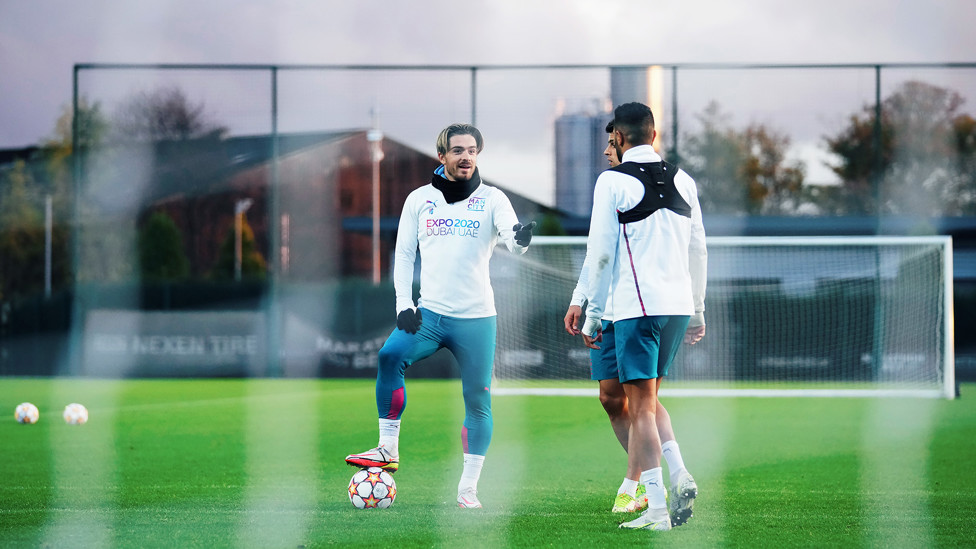 GOOD TO TALK: Jack Grealish, Joao Cancelo and Riyad Mahrez talk through one of Tuesday's training drills
