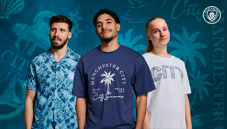 Three individuals wearing Manchester City themed clothing. The first person is in a blue patterned shirt, the second in a navy t-shirt, and the third in a white t-shirt. Manchester City logo is visible.