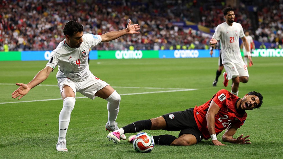 OUCH: Omar Marmoush is sent tumbling in Egypt's clash with Iran.