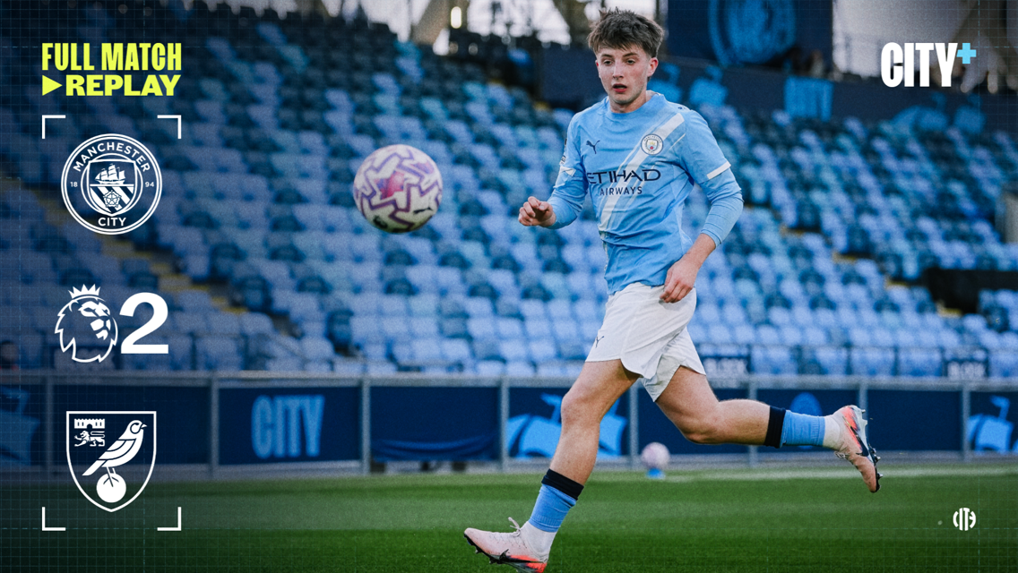 Manchester City player in an action shot during a match against Norwich City, showing a 2-0 score on the display. Manchester City logo and City+ branding visible.