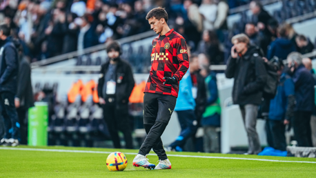 NEW BOY: Perrone gets a feel of the ball.