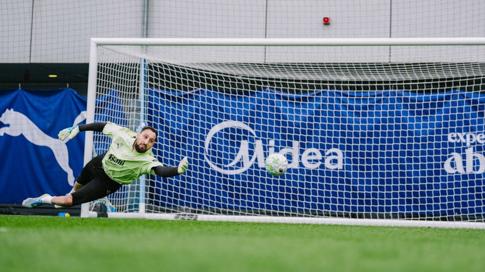LEAP OF FAITH : Gianluigi Donnarumma makes the save