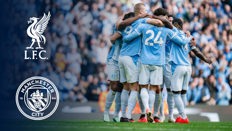 A group of Manchester City players wearing light blue jerseys huddle together on the field. The Liverpool FC logo and Manchester City logo are displayed on the left side.