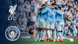 A group of Manchester City players wearing light blue jerseys huddle together on the field. The Liverpool FC logo and Manchester City logo are displayed on the left side.