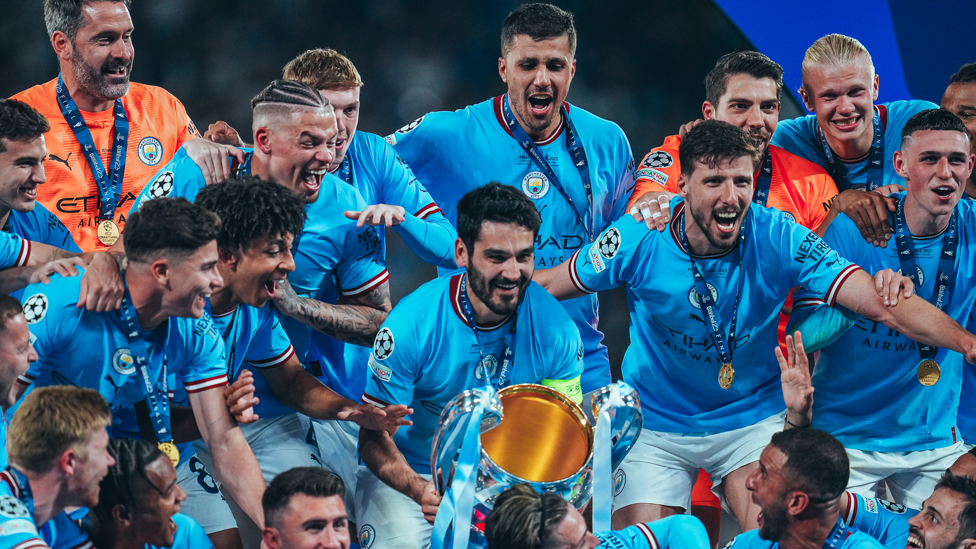 THE PAUSE : Ilkay Gundogan pauses as the crowd hype up the trophy lift