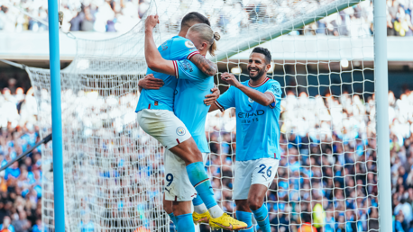 SCORER & PROVIDER: Haaland celebrates with Cancelo.