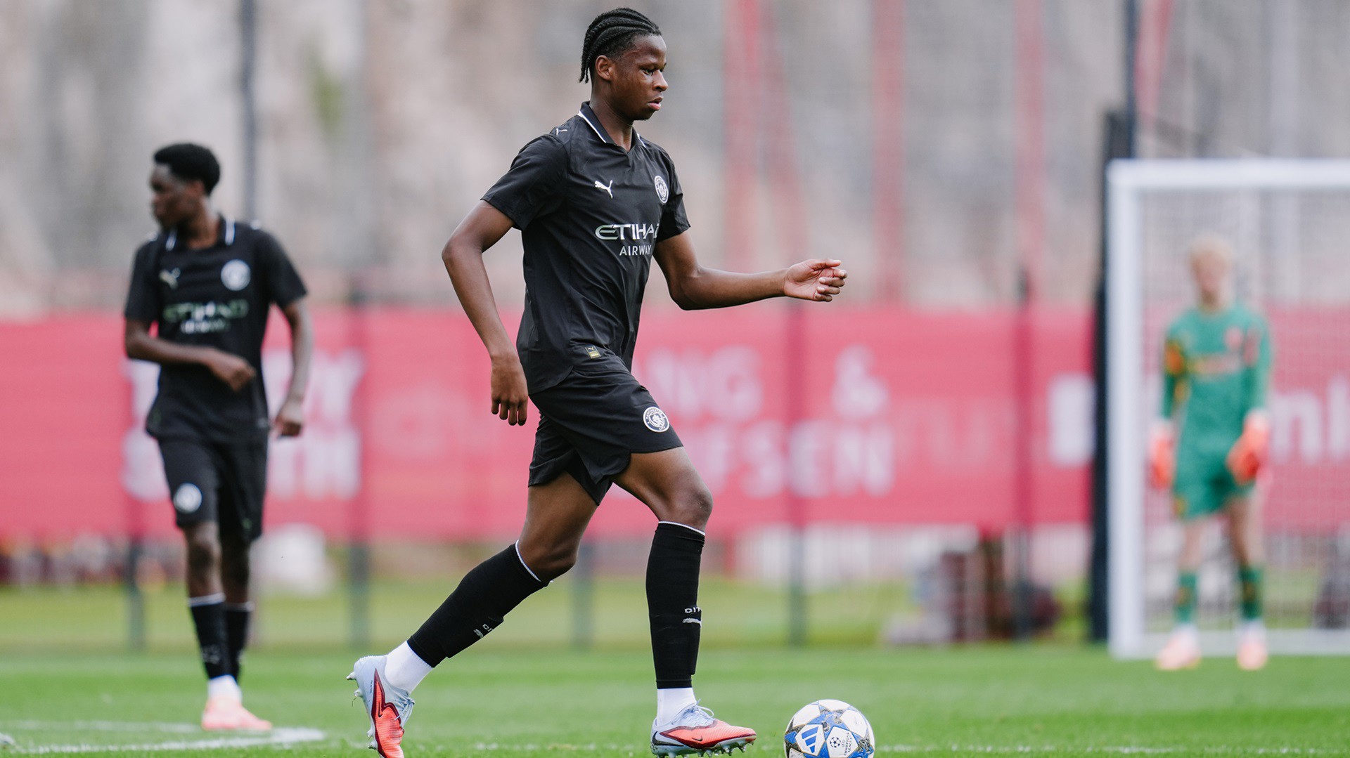 DARING DEFENDER : Stephen Mfuni carries the ball forward.