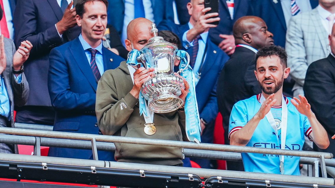SWEET KISS: The boss gets well acquainted with the trophy!