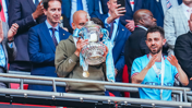 SWEET KISS: The boss gets well acquainted with the trophy!