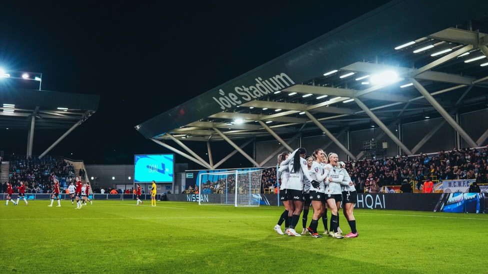 TEAM : City's players celebrate the game's first goal.