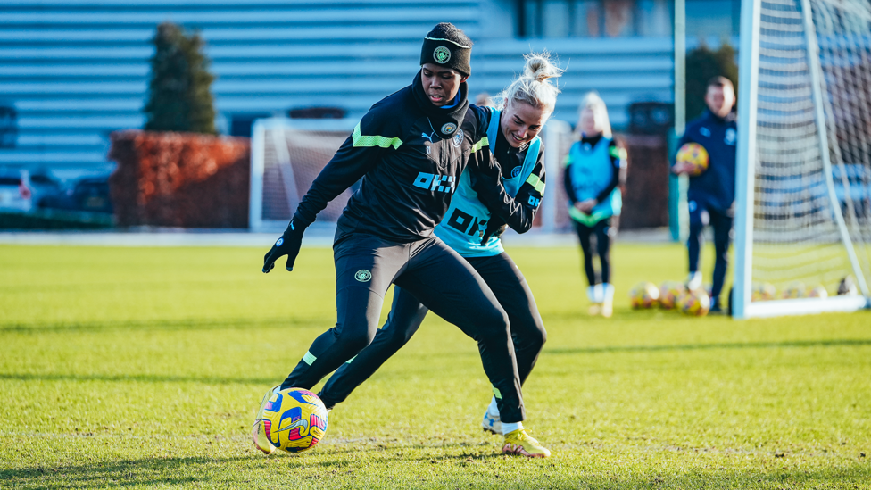 CLASH OF TITANS : Khadija 'Bunny' Shaw shields the ball from Alex Greenwood 