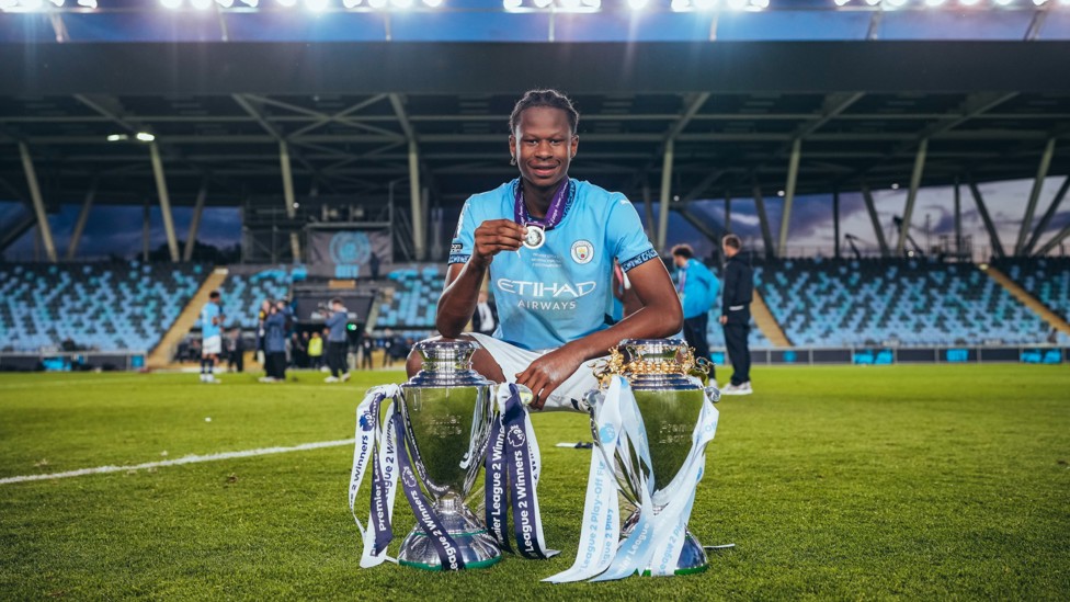 SUPER STEPHEN : Defender Stephen Mfuni showing off the silverware.