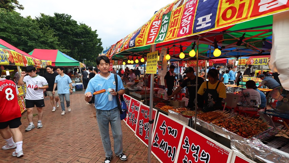 KOREAN BLUE: A City fan wanders the street food area