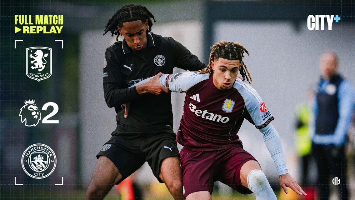 Two soccer players from Aston Villa and Manchester City compete for the ball during a Premier League match. Logos of Aston Villa and Manchester City are displayed, indicating a score of 2.