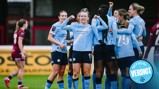 Manchester City Women's team celebrating a goal during a match, wearing light blue jerseys. A single opponent in a maroon kit is visible in the background.