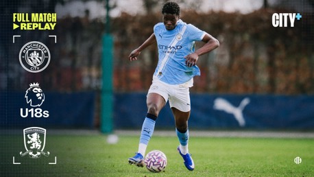 Manchester City U18 player in action during a football match. The screen displays logos for Manchester City and Middlesbrough, with Full Match Replay text on the image.