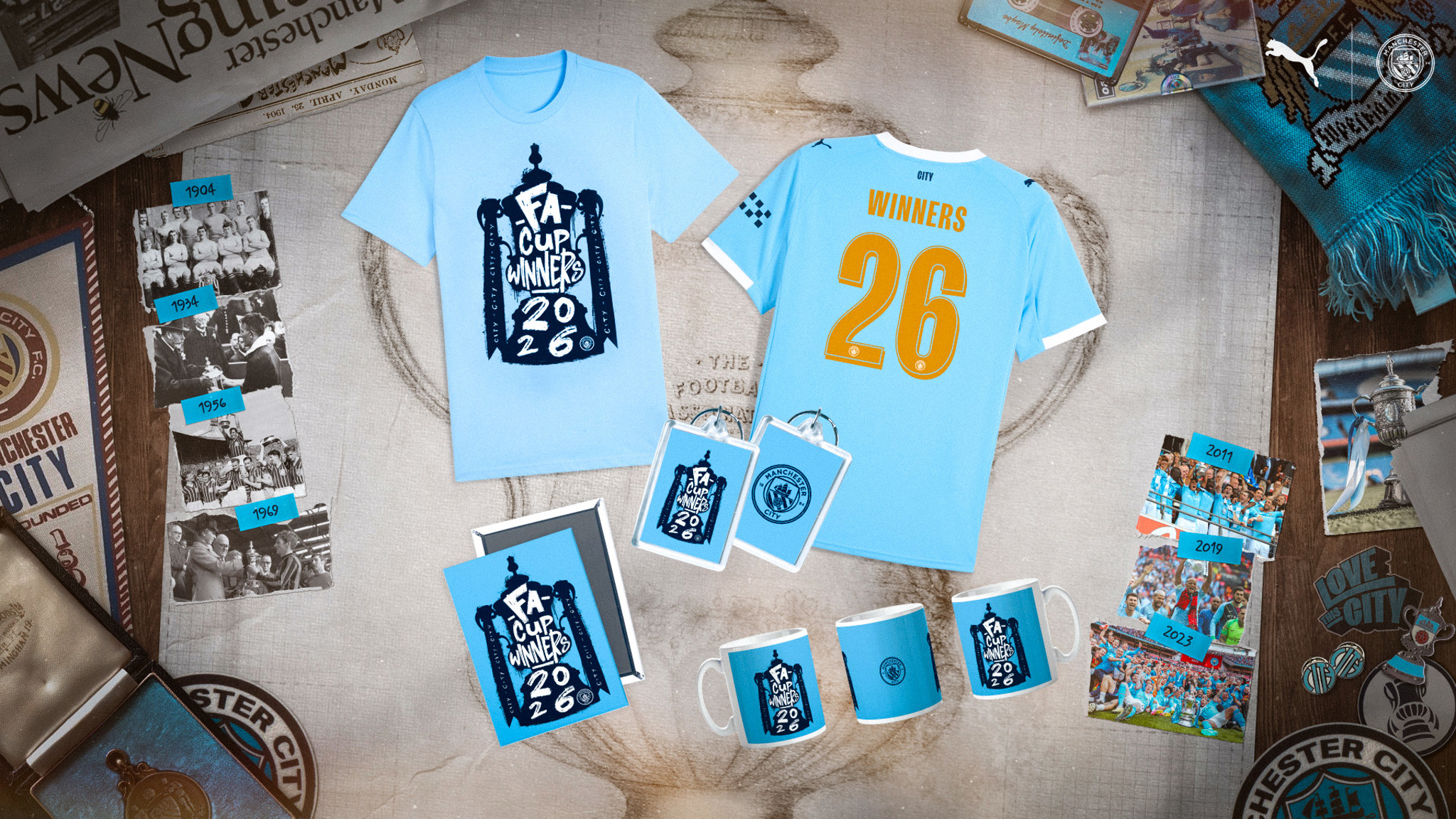 Image displays a collection of Manchester City 2026 FA Cup winner merchandise, including shirts, mugs, and historical photos.