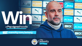 Promotional image inviting people to win a Pep signed hoodie. Includes URL to visit for lottery entry. Manchester City logo and City in the Community branding are visible.