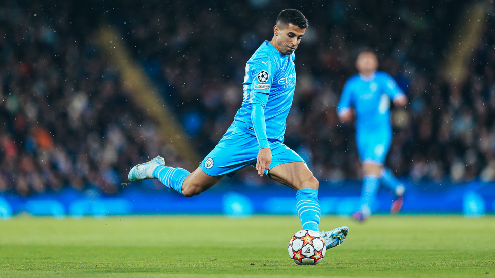 CRAFTING CANCELO : Joao eyes up the cross, looking for a route through the Atletico defence. 
