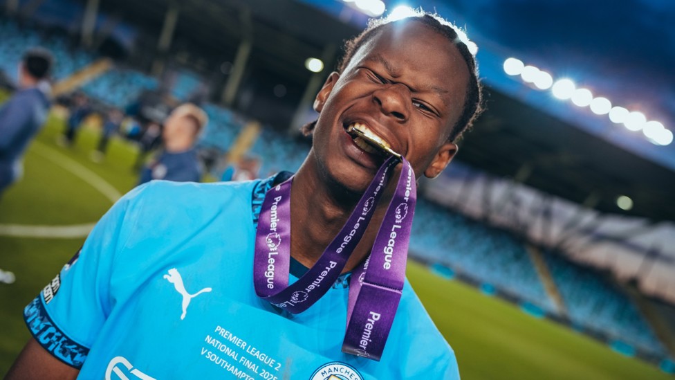 GOLD TOOTH : Stephen Mfuni poses with his PL2 winners medal. 