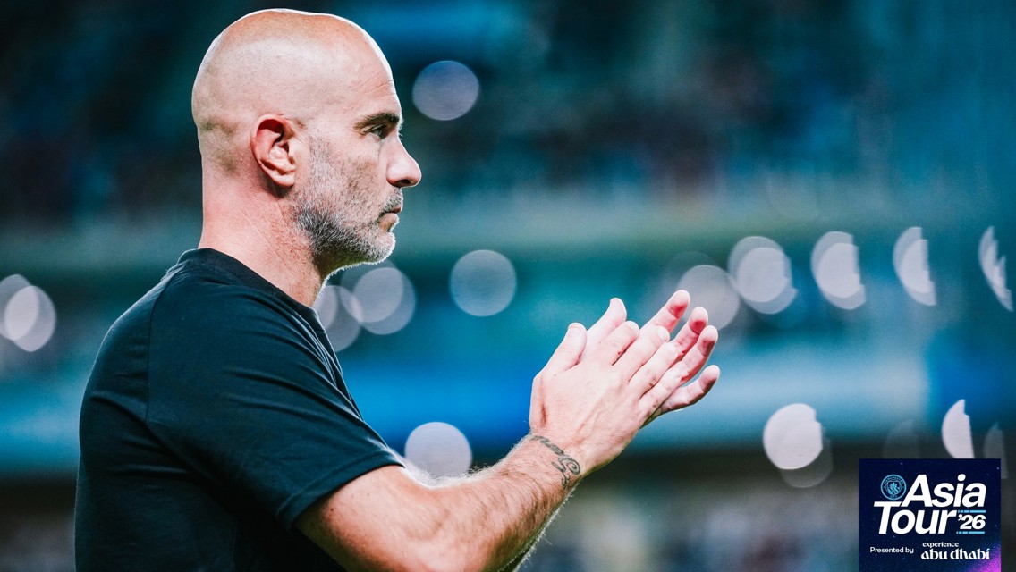 A person clapping while wearing a black shirt, with the Manchester City Asia Tour '26 logo in the bottom corner.
