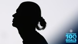 Silhouette of a person with a blurred face and a graphic celebrating Erling Haaland’s 100 goals in the Premier League with Manchester City logo.