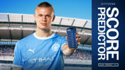 A football player in a Manchester City jersey holding a phone displaying a leaderboard of a score predictor game. The background features the Etihad Stadium.